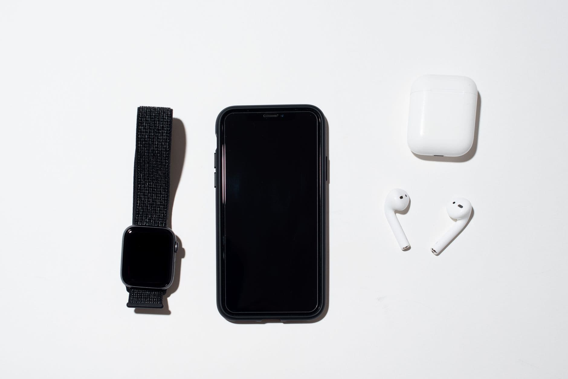 wireless earbuds with charging case on a desk