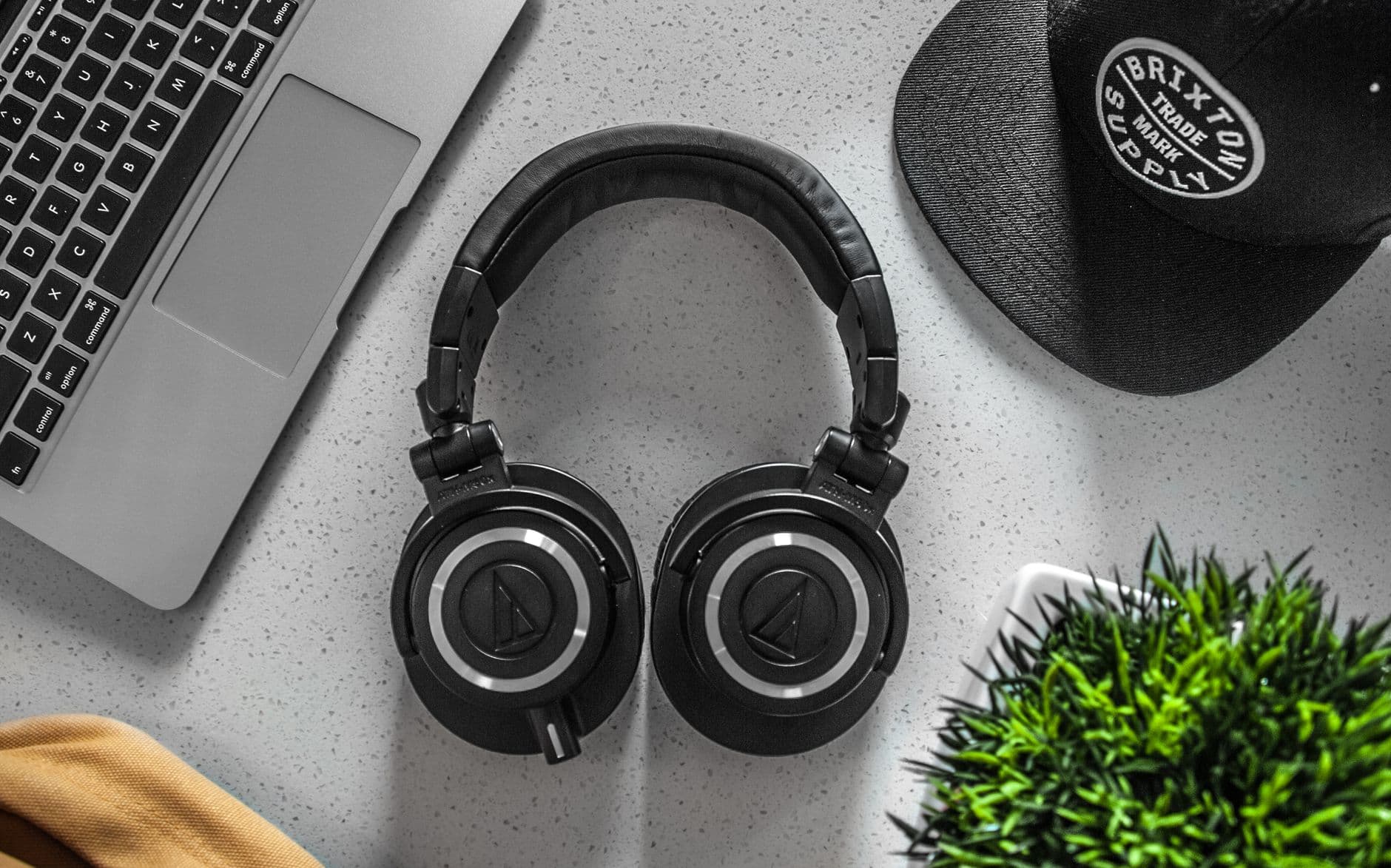 Over-ear noise-cancelling headphones on a travel carry-on bag